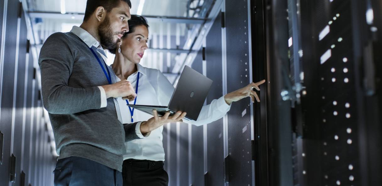 DevOps Engineer and Administrator are inspecting servers in data center
