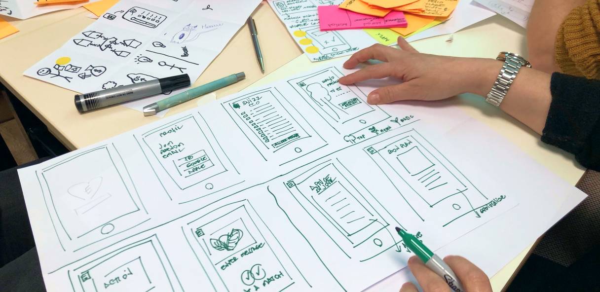 UX Designer is drawing set of wireframes