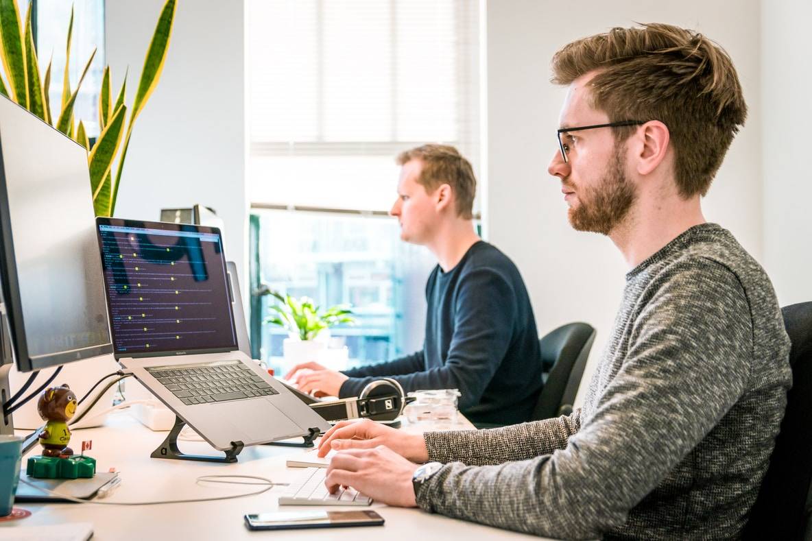 System Architect sitting in front of a computer is preparing the solution architecture